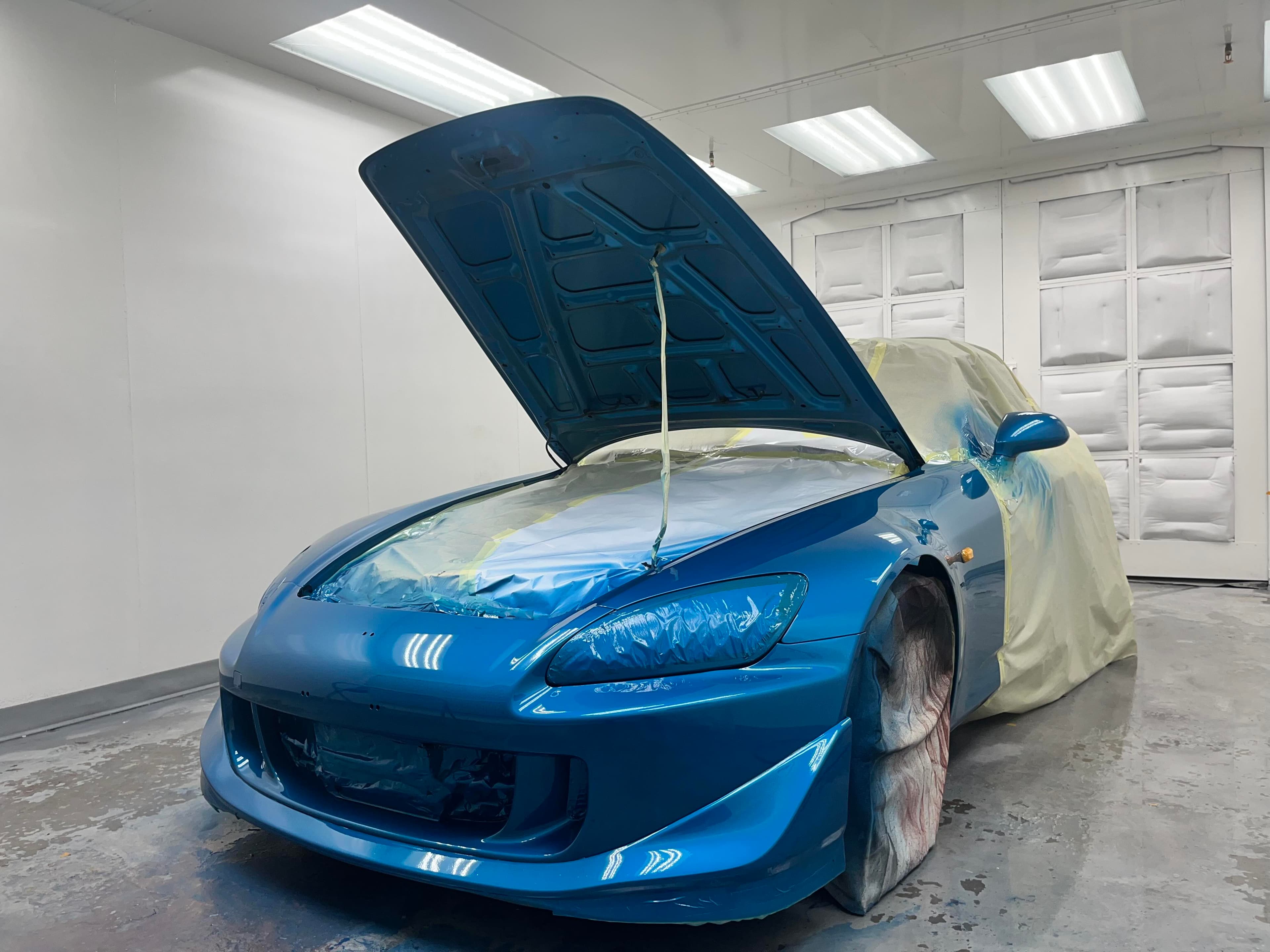 A freshly painted Honda S2000 inside the professional paint booth at Greensburg Auto Inc.
