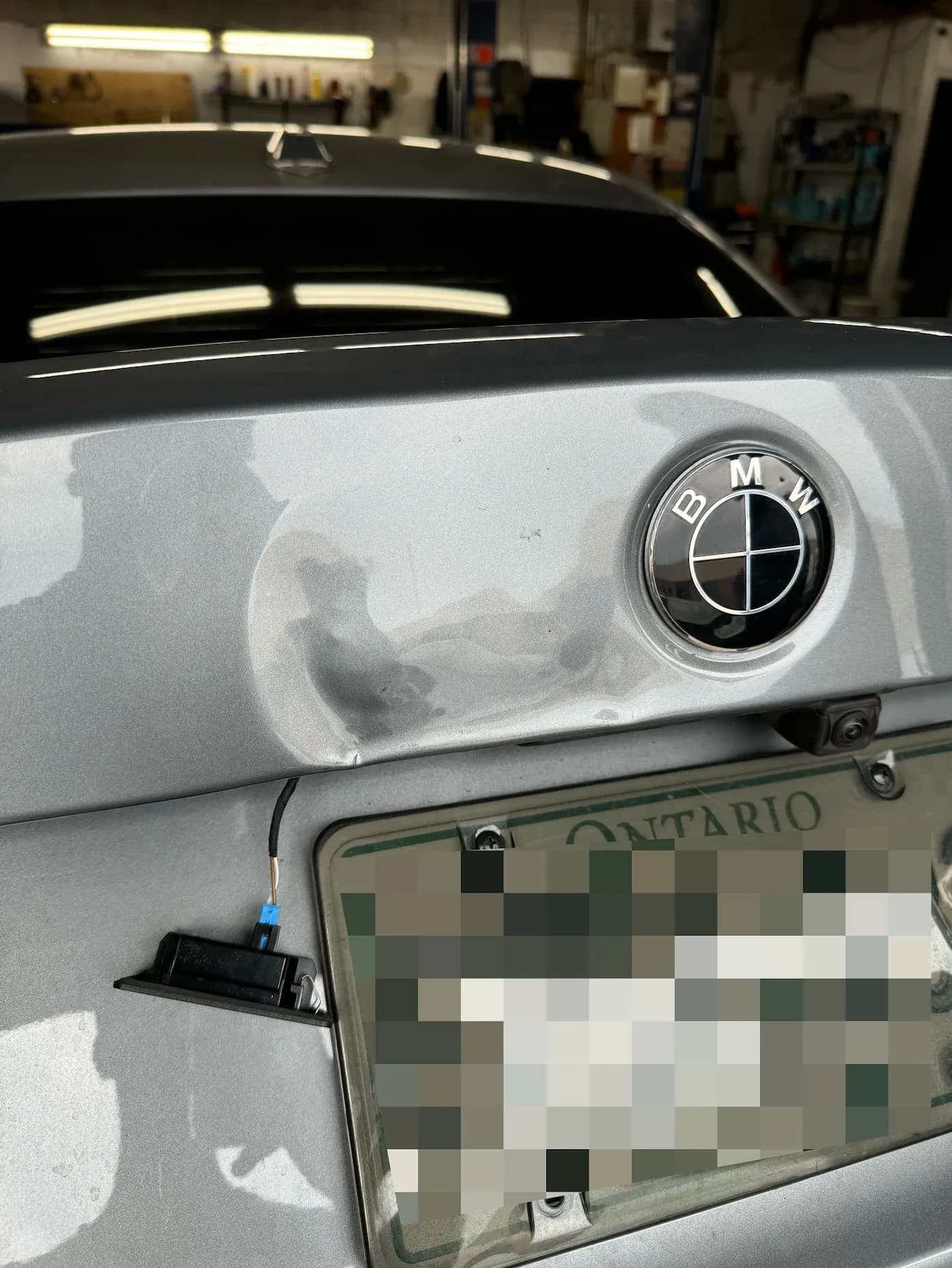 BMW 330i trunk lid dent