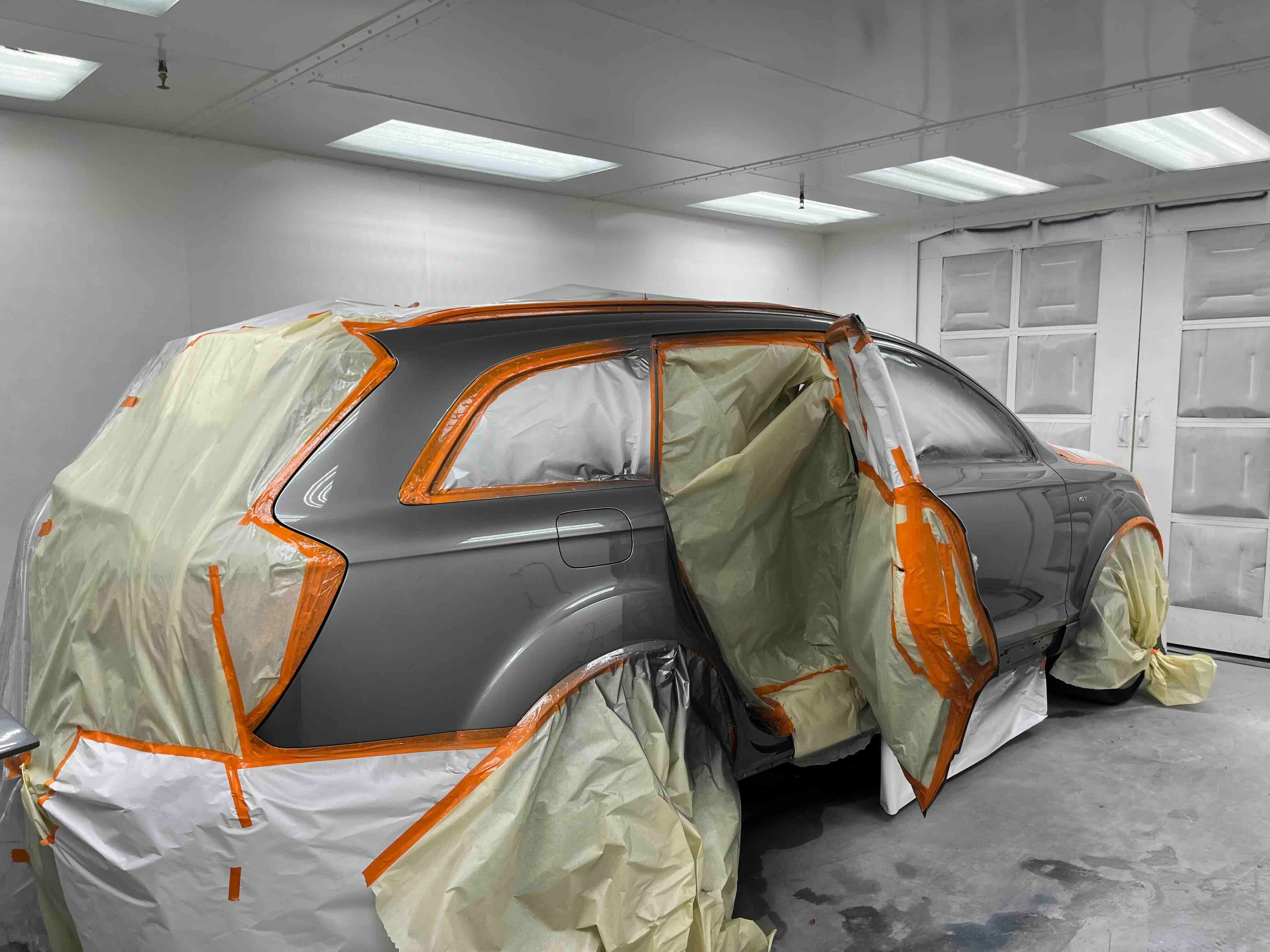 Audi Q7 with panels masked for professional auto painting at Greensburg Auto