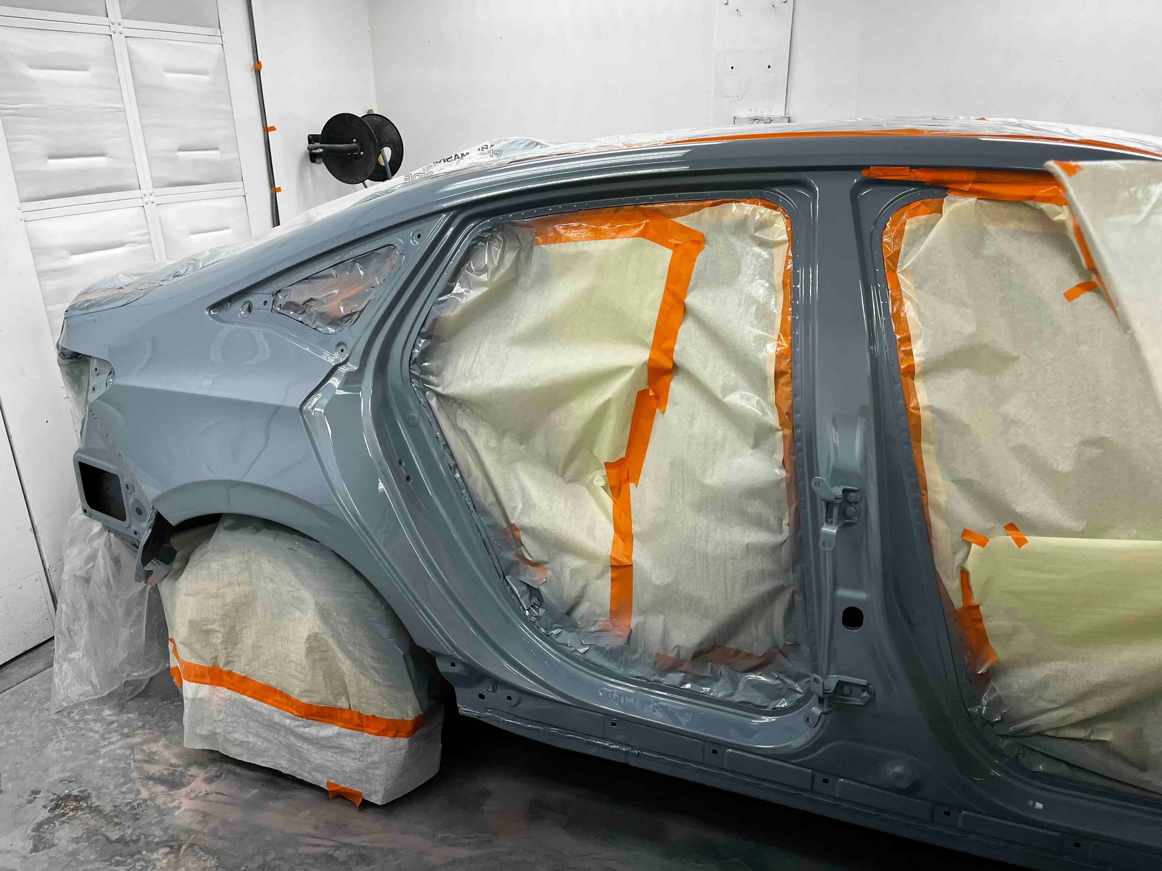 Honda Civic masked and prepared for auto painting in the Greensburg Auto paint booth